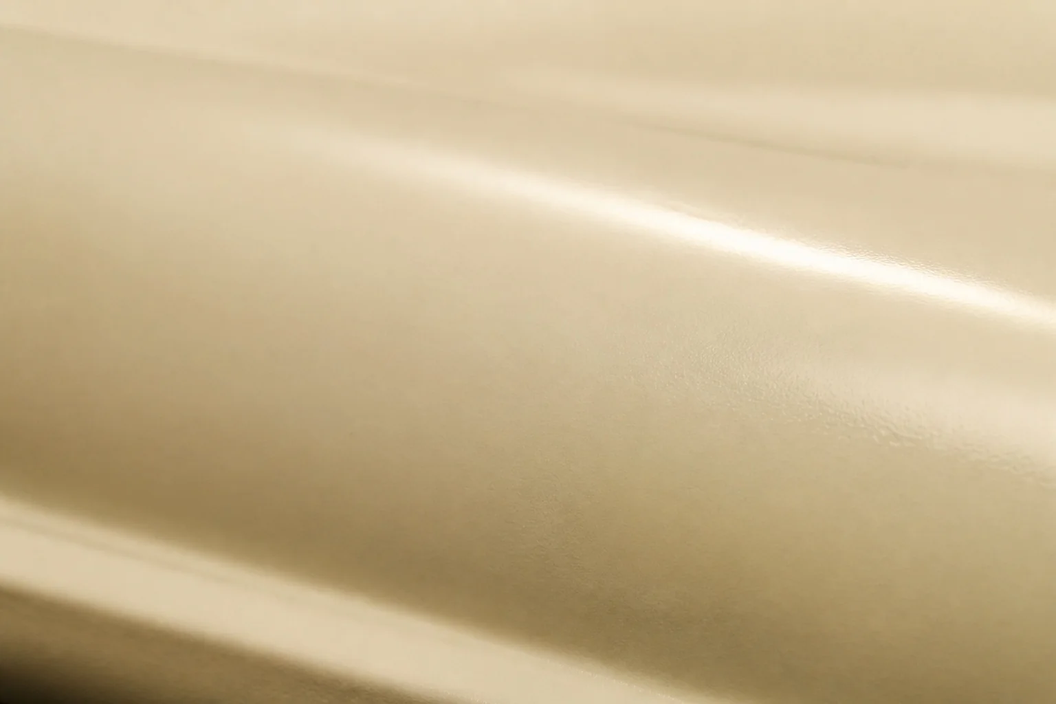 Close detail of warm ivory automotive paint and its polished surface.